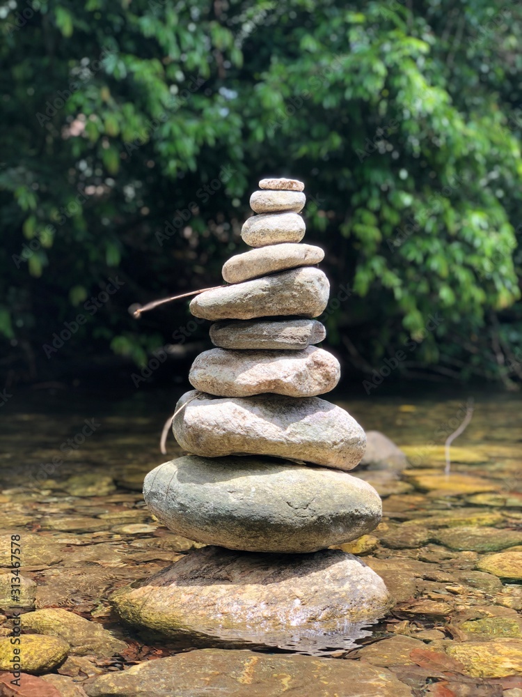 stack of stones on background of blue sky and clouds stack of stones on background of blue sky and clouds