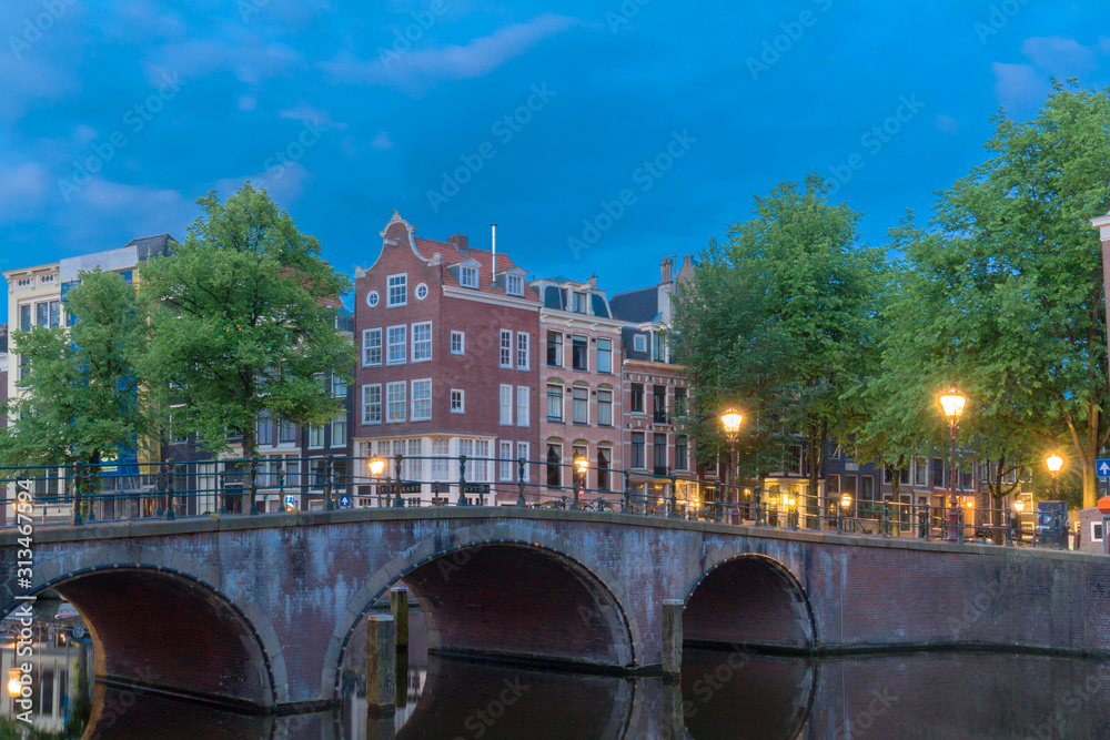 Naklejka premium Beautiful view of Amsterdam canals with bridge and typical dutch houses. Holland