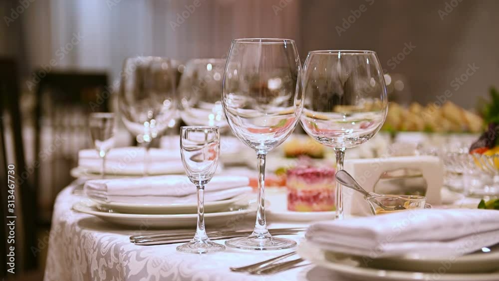 Banquet decorated table, with cutlery. Wedding decor in the banquet hall. Banquet decorated table, with cutlery. Wedding decor in the banquet hall.