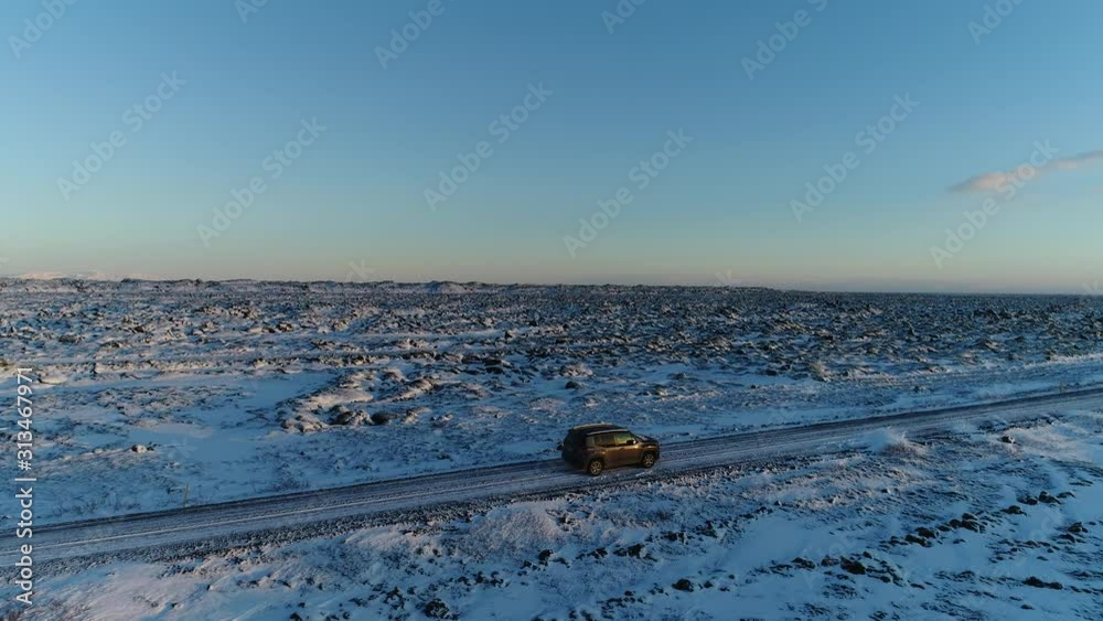 Car 4x4 driving along in Iceland landscape during winter Car 4x4 driving along in Iceland landscape during winter