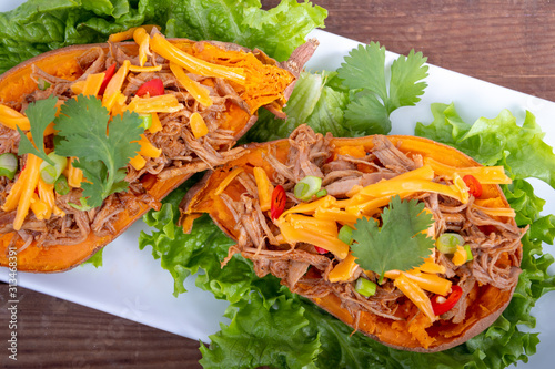 delicious spicy pulled pork stuffed sweet potato dish photo