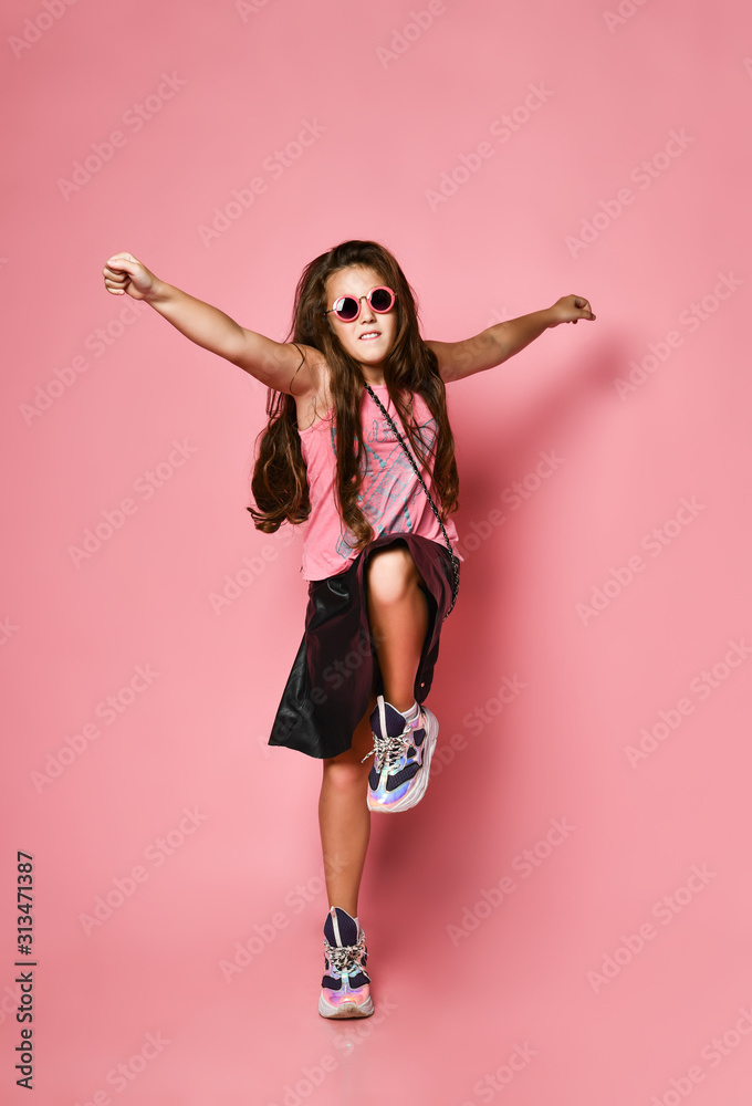 Young happy plus size girl model in stylish summer casual clothing, accessories and sneakers jumping and feeling excited Young happy plus size girl model in stylish summer casual clothing, accessories and sneakers jumping and feeling excited