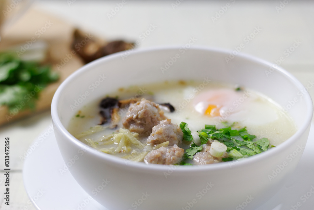 Rice porridge ,congee with minced chicken and Soft-boiled egg in white bowl Rice porridge ,congee with minced chicken and Soft-boiled egg in white bowl