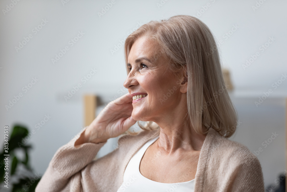 Happy senior woman look in distance dreaming or thinking Happy senior woman look in distance dreaming or thinking