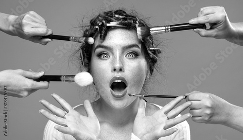 Beauty girl with makeup brushes around.