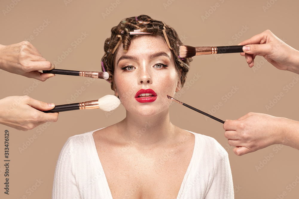 Beauty girl with makeup brushes around.