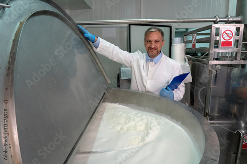 Dairy Plant Food Technologist Checking Milk Pasteurization Process photo