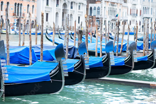 Gondolas moored by Saint Mark square with San Giorgio di Maggiore church in Venice, Italy, © YuliiaMazurkevych