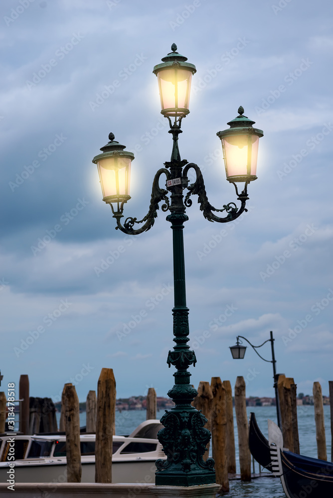 Authentic pink Venice street lantern with the pigeons in Venice, Italy