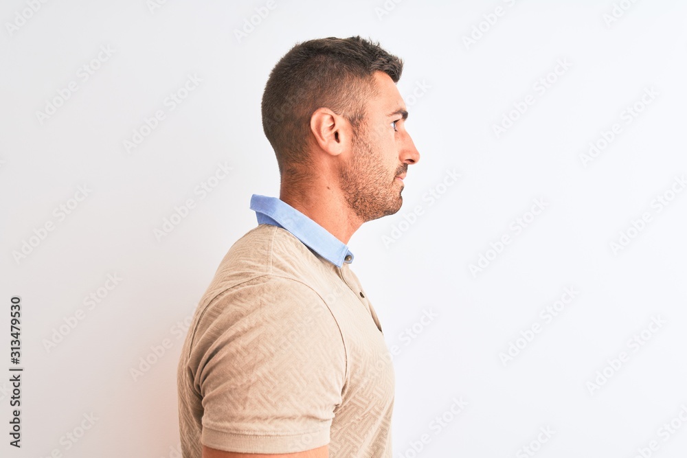 Young handsome man wearing elegant t-shirt over isolated background looking to side, relax profile pose with natural face with confident smile. Young handsome man wearing elegant t-shirt over isolated background looking to side, relax profile pose with natural face with confident smile.