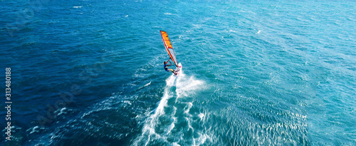 Aerial drone ultra wide photo of wind athlete surfer practising in deep blue open ocean sea © aerial-drone