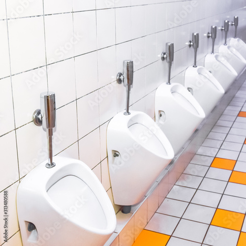 men's toilet with a number of urinals in a theater or restaurant 