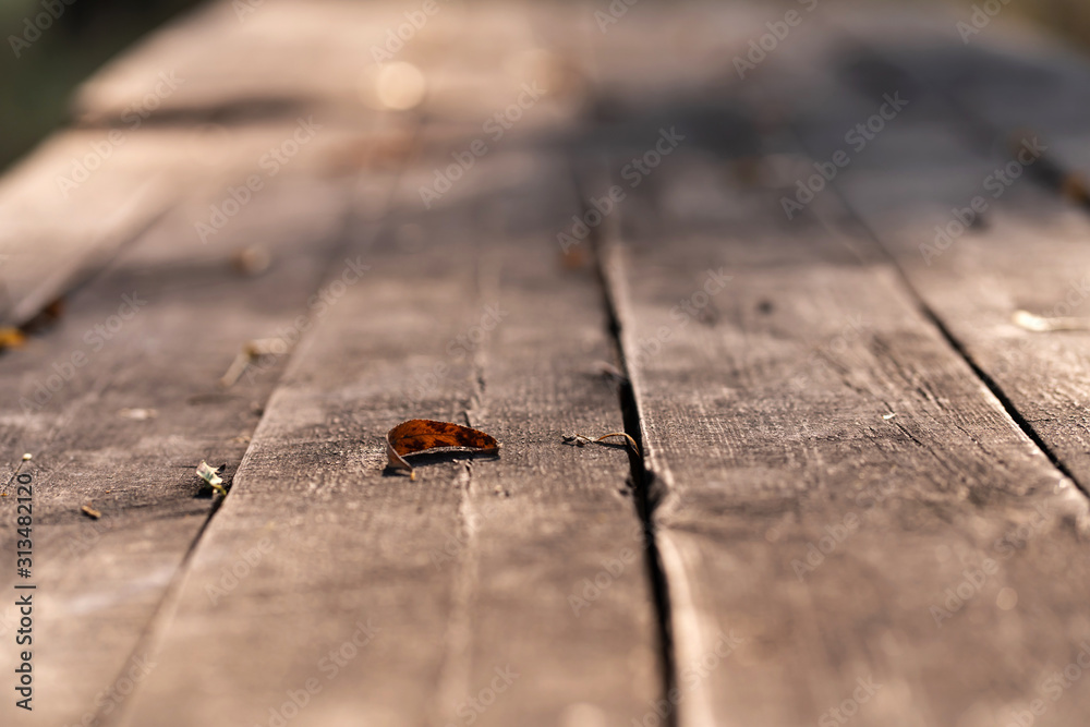 Fototapeta premium Autumn fallen yellow leaves of trees on a wooden floor. Autumn mood