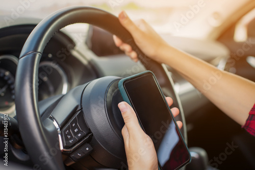 Woman with smartphone in car