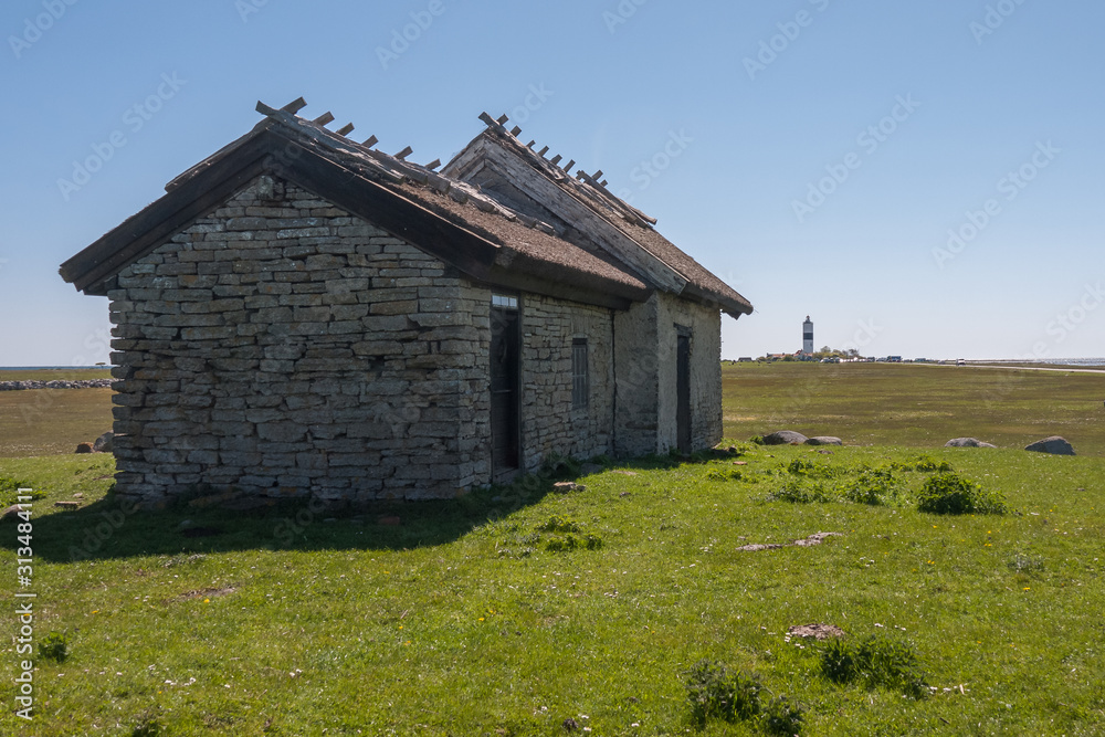An old stone house stands on a green meadow. Oland, Sweden An old stone house stands on a green meadow. Oland, Sweden