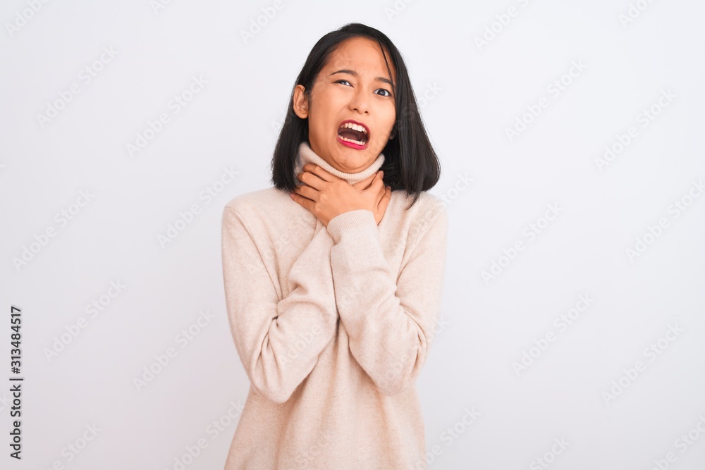 Young chinese woman wearing turtleneck sweater standing over isolated white background shouting suffocate because painful strangle. Health problem. Asphyxiate and suicide concept. Young chinese woman wearing turtleneck sweater standing over isolated white background shouting suffocate because painful strangle. Health problem. Asphyxiate and suicide concept.