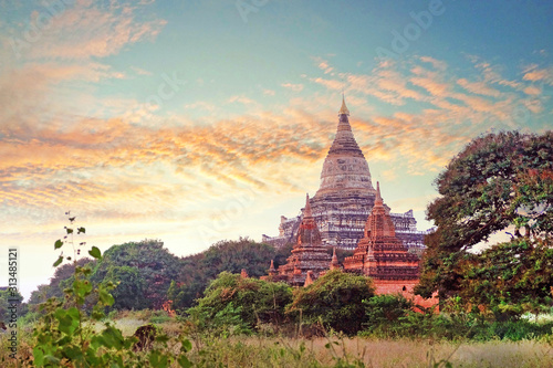 Colorful sunset sky above temples surrounded by green vegetation in old Bagan  Myanmar.