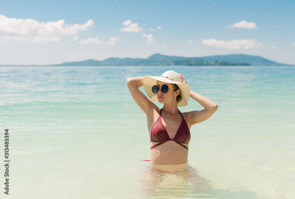 portrait beautiful fun joy sexy smiling brunette woman burgundy bikini sunglasses. In the background the sea. Tropical hot sun blue sea water resort, tan skin body, slim travel nature lifestyle. portrait beautiful fun joy sexy smiling brunette woman burgundy bikini sunglasses. In the background the sea. Tropical hot sun blue sea water resort, tan skin body, slim travel nature lifestyle.