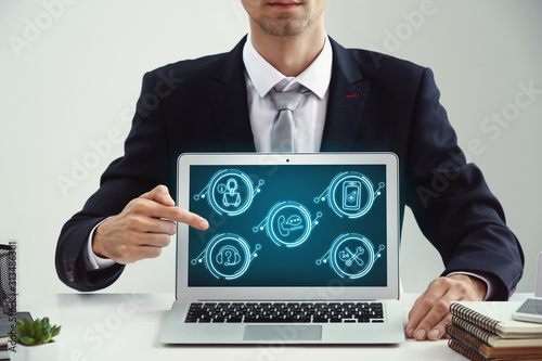 Businessman pointing on ico...