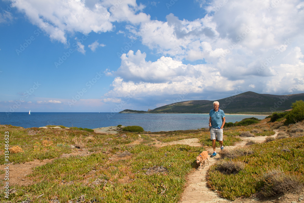 Man walking at coast from Corsica