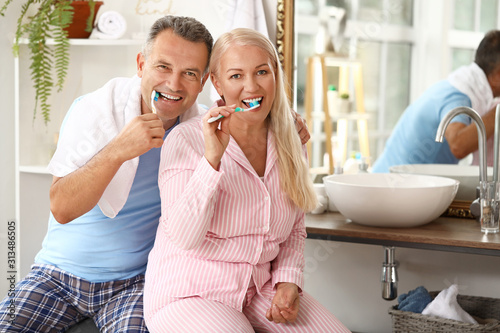 Mature couple brushing teet...