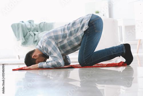 Muslim man praying at home
