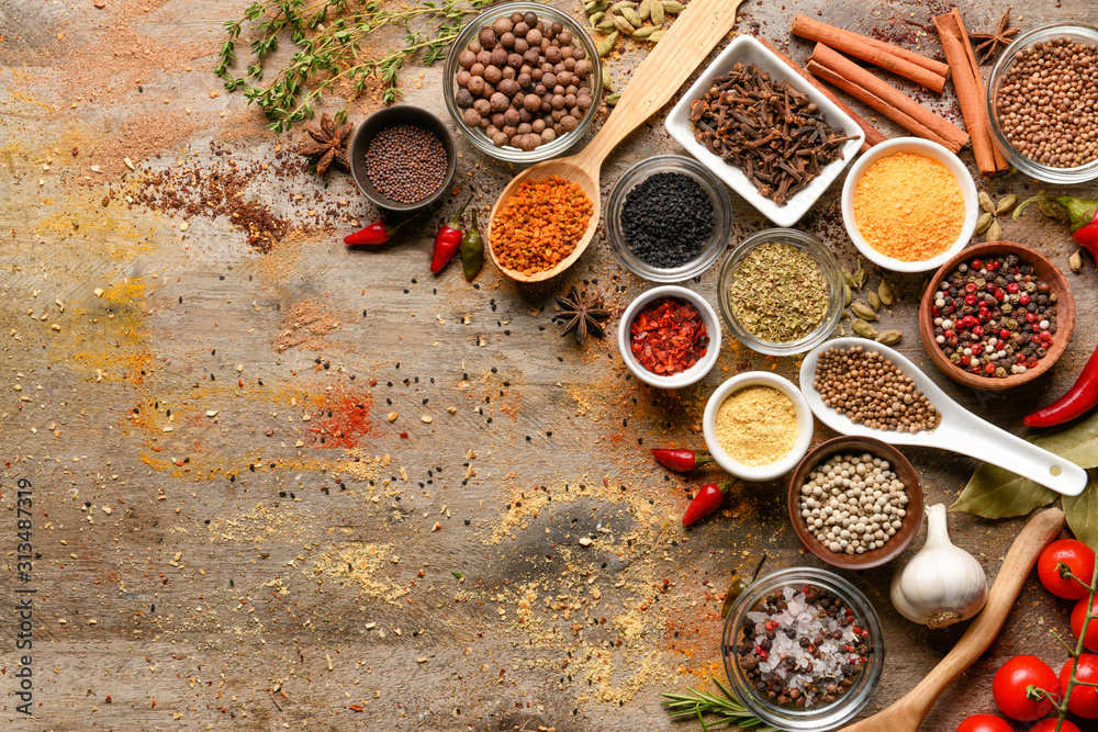 Different spices on wooden background