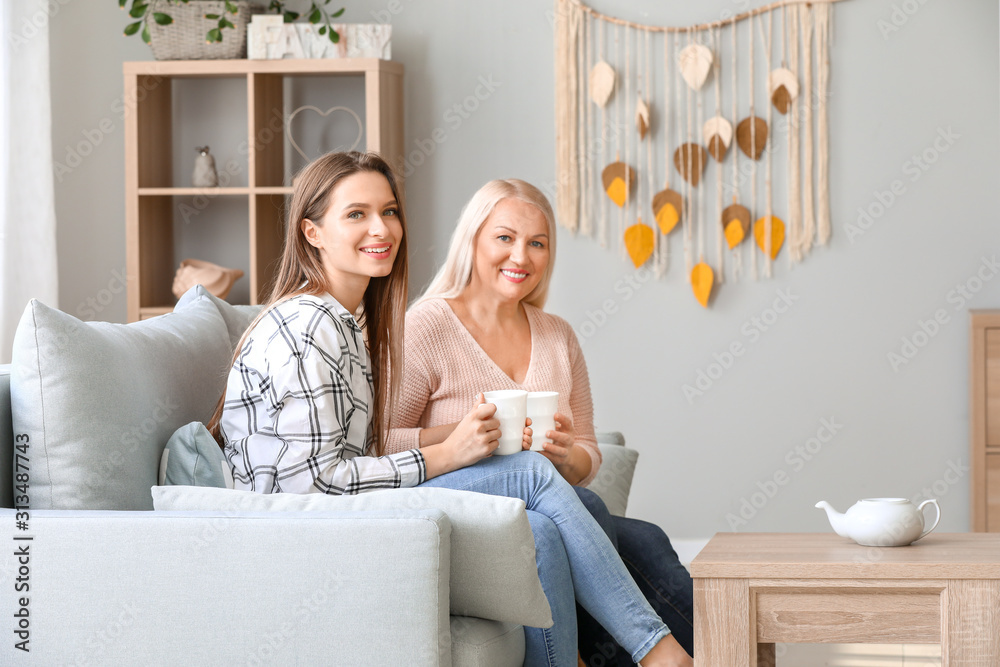 Mature woman and her adult daughter spending time together at home Mature woman and her adult daughter spending time together at home