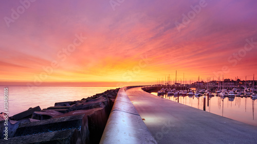 Fotografija Amazing sky on sunrise at Greystones yacht marina or harbour with anchored boats and long illuminated pier