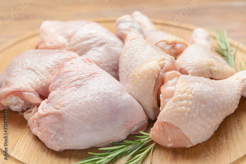 Raw chicken meat on wooden board, closeup