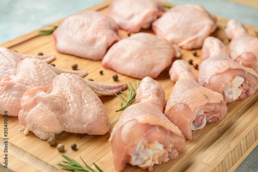 Raw chicken meat on wooden board