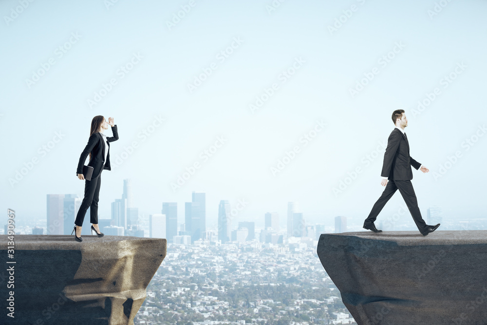 Businesswoman looking on businessman standing on mountain. - obrazy, fototapety, plakaty 
