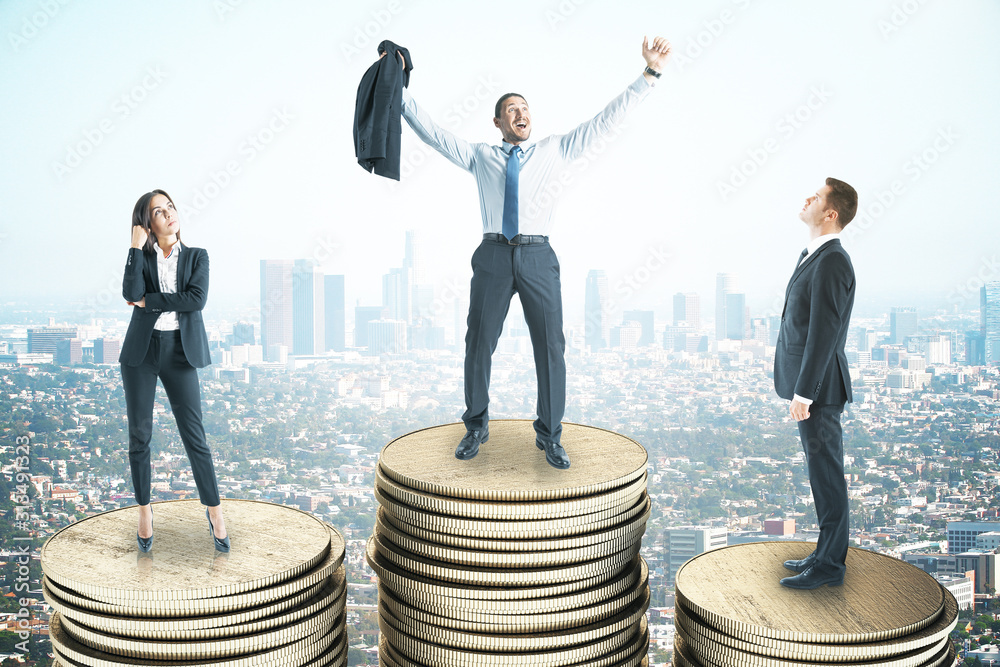 young businesspeople standing on golden coin young businesspeople standing on golden coin