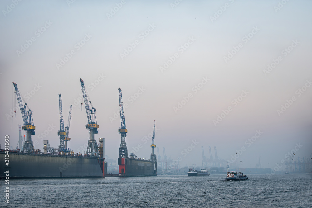 Docks of Hamburg harbor with cranes