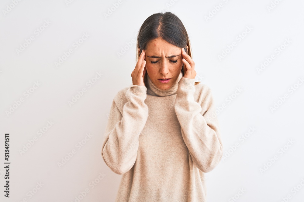 Beautiful redhead woman wearing winter turtleneck sweater over isolated background with hand on head for pain in head because stress. Suffering migraine. Beautiful redhead woman wearing winter turtleneck sweater over isolated background with hand on head for pain in head because stress. Suffering migraine.
