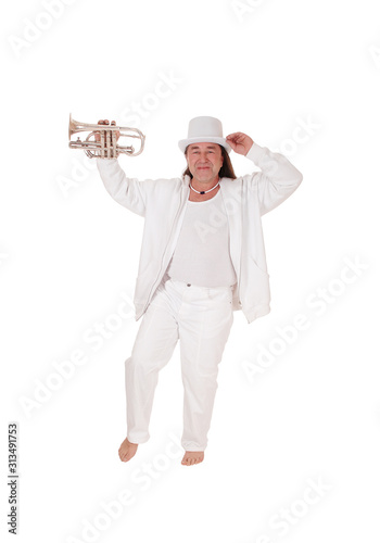 A trumpet player standing in a white outfit and hat