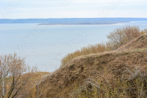 Stony  pebble and clay banks of the Volga River. Mountain slope of various stone rocks. Spring cloudy day with rain. Beautiful spring landscape. Tetyushi  Tatarstan.