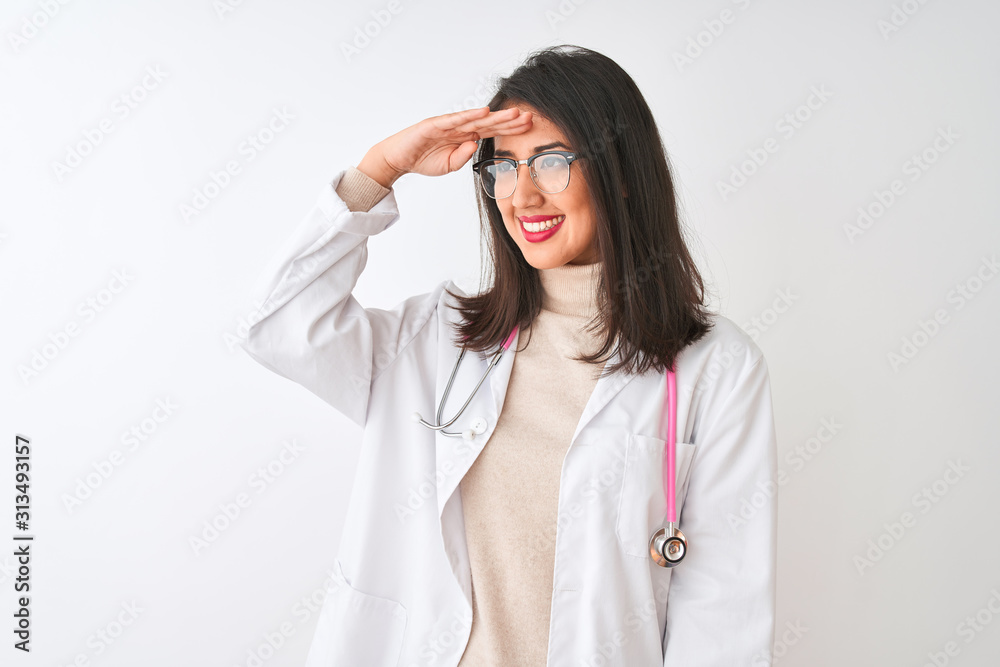 Chinese doctor woman wearing coat and pink stethoscope over isolated white background very happy and smiling looking far away with hand over head. Searching concept. Chinese doctor woman wearing coat and pink stethoscope over isolated white background very happy and smiling looking far away with hand over head. Searching concept.