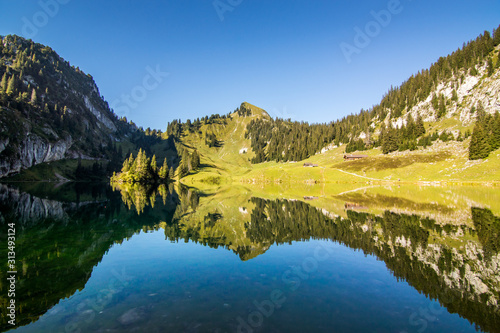 clear lake in the alps with great reflection and blue sky in summer