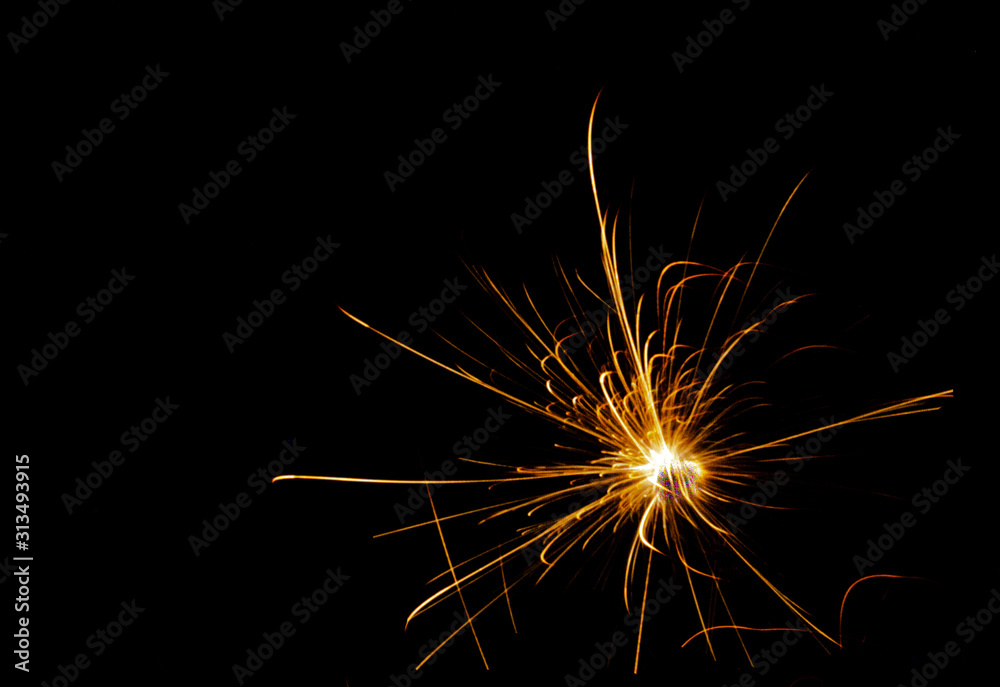 Blur abstract of yellow sparkly fireworks against black background, vivid color illustration