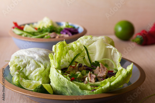 Stuffed iceberg lettuce cabbage leaves with chicken and vegetables. Wraps pockets of lettuce with chicken