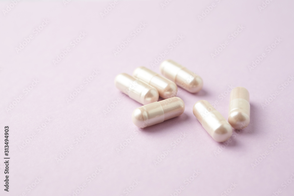 Carnitine capsules. Concept for a healthy dietary supplementation. Bright paper background. Close up. Copy space. Carnitine capsules. Concept for a healthy dietary supplementation. Bright paper background. Close up. Copy space.