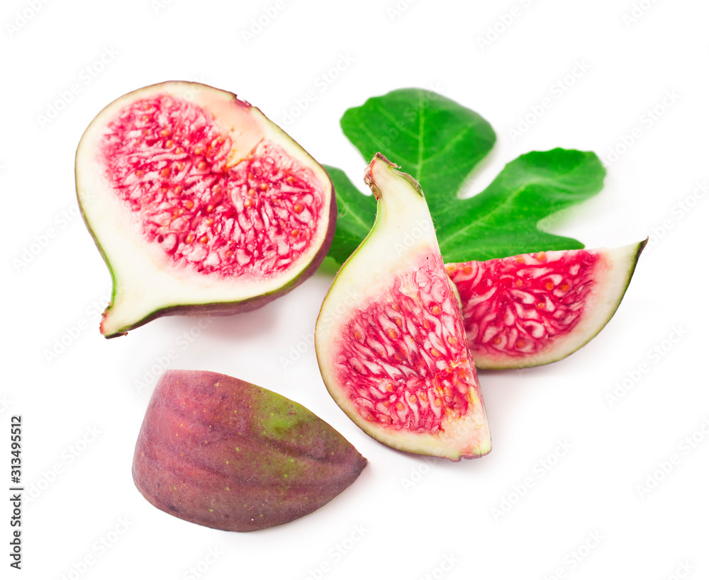 Sliced fresh figs on a fig leaf isolated on white background
