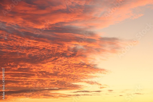 Sunset over the southern calm sea and scarlet thick clouds