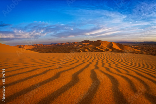 Desert landscape near Merzouga, small village in Morocco, known for its proximity to Erg Chebbi, tourists visiting Morocco, described as a desert theme park, and the Erg Chebbi as a wonderland of sand