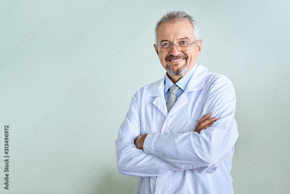 Cheerful mature doctor posing and smiling at camera, healthcare and medicine. Cheerful mature doctor posing and smiling at camera, healthcare and medicine.