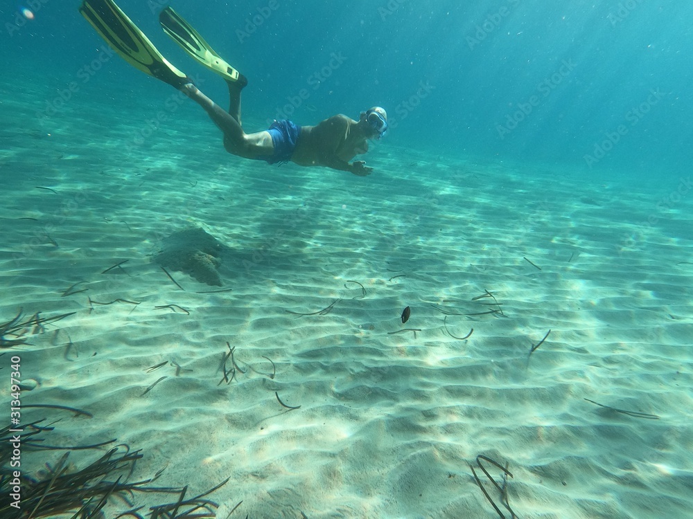 underwater man snorkeling in the sea withcrystal-clear waters concept of holiday relax summer beach diver in the sea