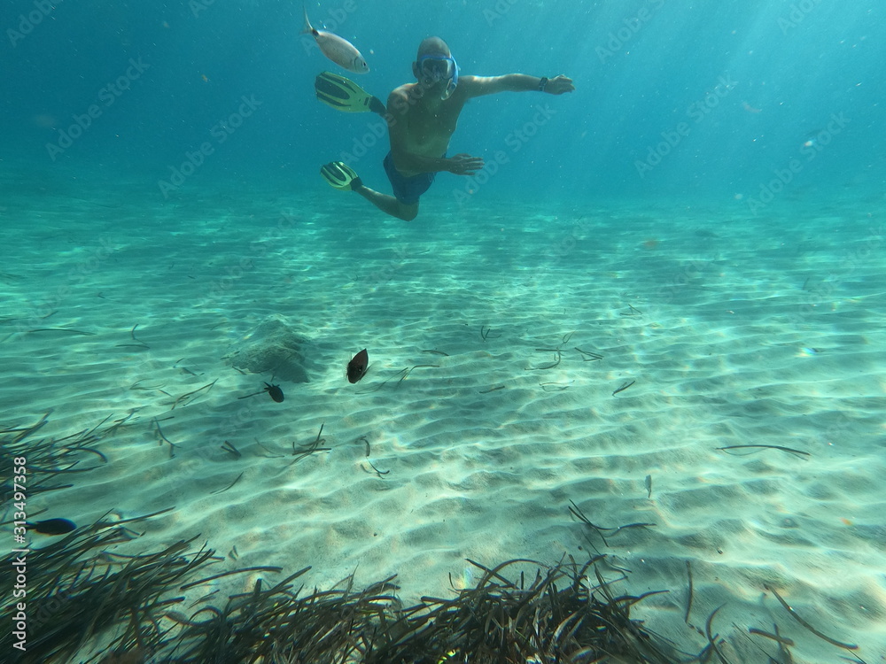 underwater man snorkeling in the sea withcrystal-clear waters concept of holiday relax summer beach diver in the sea