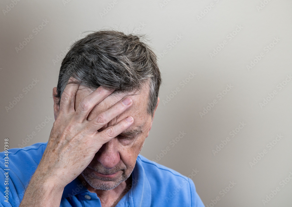 Head and shoulders portrait of a senior caucasian man with head in hands and looking depressed Head and shoulders portrait of a senior caucasian man with head in hands and looking depressed