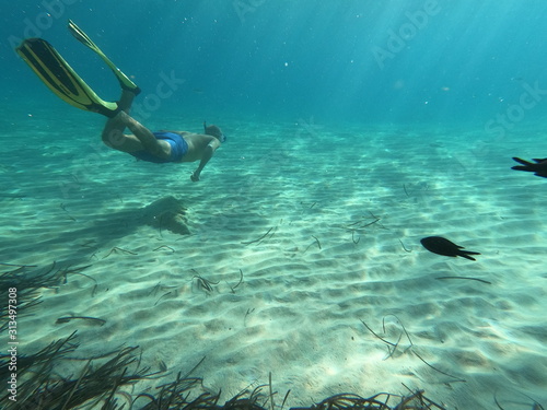 underwater man snorkeling in the sea withcrystal-clear waters concept of holiday relax summer beach diver in the sea